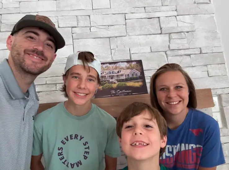 Zach and Michelle smile with their two sons after purchasing their new home with Burson Home Advisors in North Carolina